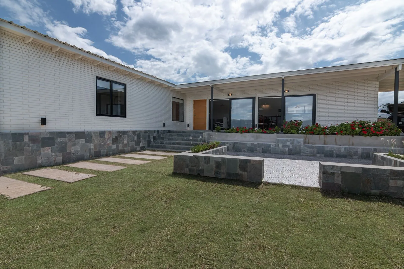 Front elevation of a white wooden block villa